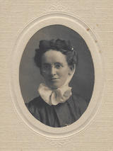black and white portrait in oval cardboard frame